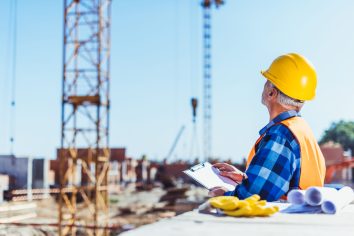 construction worker writing on clipboard