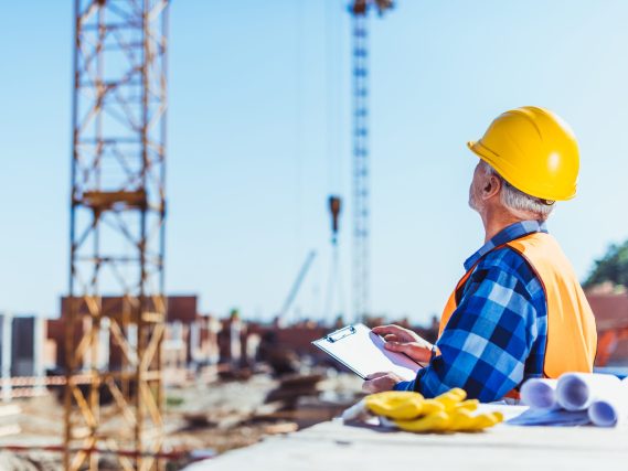 construction worker writing on clipboard